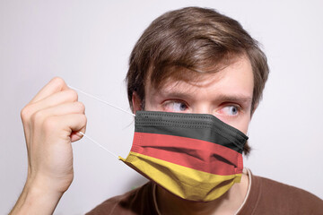 Young man wearing Germany face mask during coronavirus pandemic