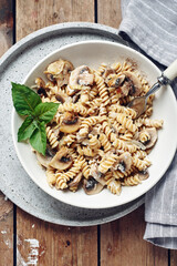 Fusilli pasta with mushrooms and cheese.