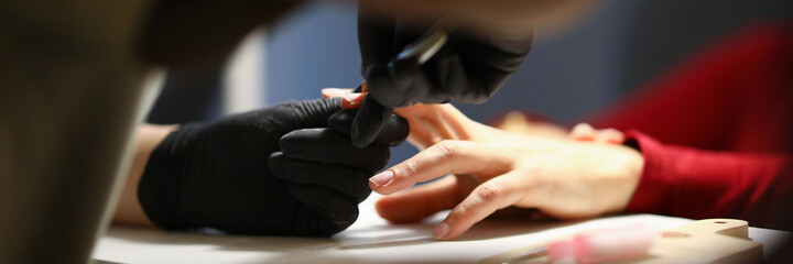 The manicurist processes the cuticles in the salon or at home during quarantine. Standard set for creating manicure