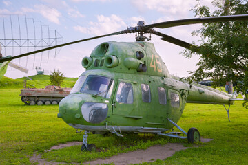 Soviet-era military helicopter, Russia. A small green helicopter - 407261045