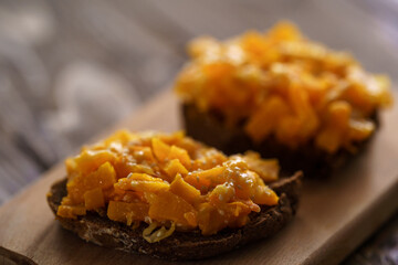 Delicious sandwiches of baked pumpkin with cheese, sesame seeds on grain bread
