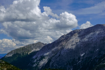 clouds over steep mountains while hiking detail