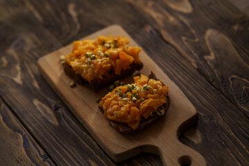 Delicious baked pumpkin sandwiches with cheese, sesame seeds and Mung bean