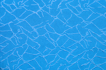 Bright blue background with white embroidery in the form of cracks.