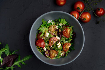 Healthy food. Greek salad with cucumber, tomato, sweet pepper, lettuce and feta cheese. Top view, copy space