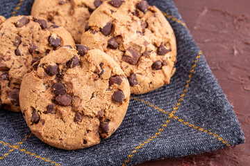 dark chocolate chip cookie round gold concept Organic fresh bake homemade tasty sweet dessert piece of closeup on cookie on wooden table for holiday new year Christmas gift sugar sparkle
