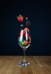 A glass of berries mix on a dark background.