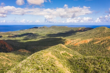 Aerial view above scenery of Curacao, Caribbean with ocean, coast, hills, lake