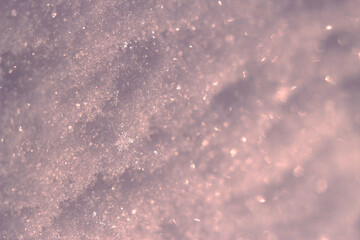 blurred and sparkling fluffy snow in sunny evening - frozen close up, winter background