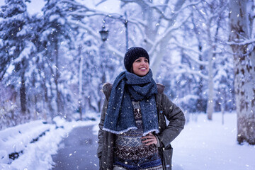 Fototapeta na wymiar Beautiful happy female in the winter walk outdoors with a lot of snow