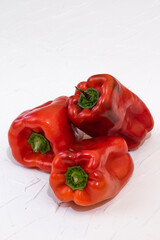 Three red bell peppers on the white background