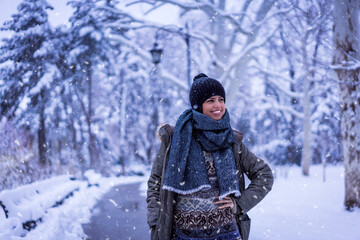 Fototapeta na wymiar Beautiful happy female in the winter walk outdoors with a lot of snow