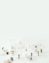 People (figurine) standing in empty  vaccine glass vials.Coronavirus covid-19 vaccine development to fight against coronavirus pandemic..Healthcare And Medical concept.
