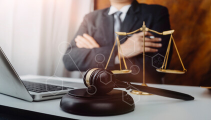 Business and lawyers discussing contract papers with brass scale on desk in office. Law, legal services, advice, justice and law concept  picture with film grain effect