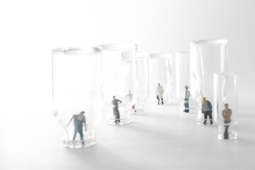 People (figurine) standing in empty  vaccine glass vials.Coronavirus covid-19 vaccine development to fight against coronavirus pandemic..Healthcare And Medical concept.