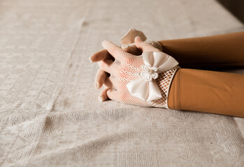 girl in  gloves with decorative bows 