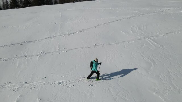 Ski touring adventure in Beskidy Mountains, Poland. Man backcountry skiing in fresh powder snow.
