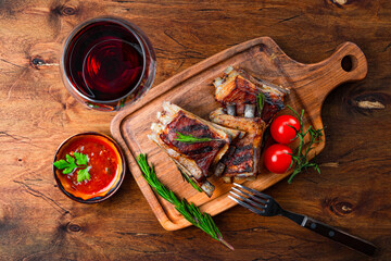  Grilled ribs in barbecue sauce and a glass of red wine top view