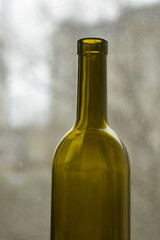 A green bottle for wine and delicious tangerines.
