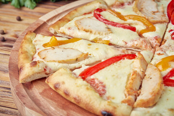 Pizza with meat, vegetables and mushrooms, wooden background