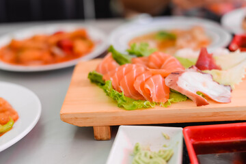 Japan of raw fresh fish fillet, sashimi mix salmon and tuna set on wooden board