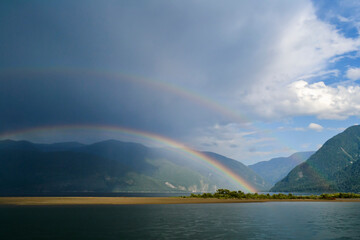 Naklejka na ściany i meble Beautiful double rainbow above Teletskoe lake after heavy rain.