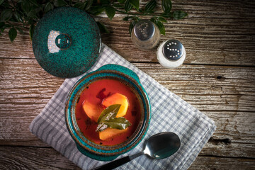 Red borscht soup in bowl.