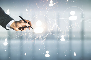 Naklejka premium Man hand with pen working with abstract virtual social network hologram on blurred office background. Double exposure