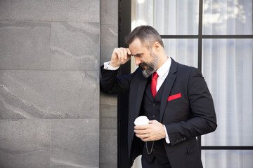 Businessman in Suit Holding a Cup of Coffee with Depression