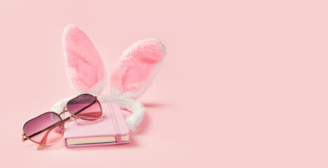 Pink girlie fluffy bunny ears with notepad and sunglasses on pink banner. Happy Valentines day greeting card or fancy dress invitation. Hen party. Copy space