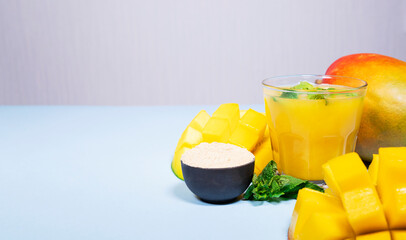 Mango Shake wit Maca on Blue Background. Healthy Drinking Vitamin Smoothie. Fresh Tropical Mango...