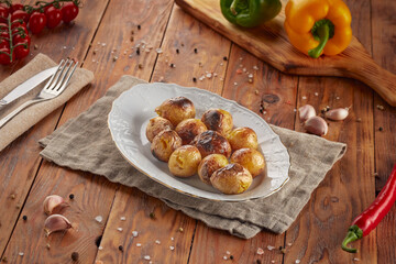 BBQ grilled potatoes, wood background