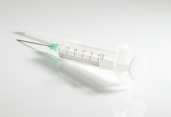 Small syringe with a sharp, beveled needle used to inject medications.