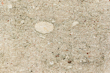 Apply sand rubbing plaster to masonry on concrete. Scratched and cracked dirty weathered sand textured plaster surface texture.