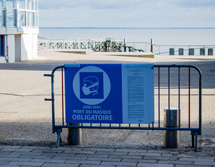 Vendée, France; January 15, 2021: be careful wearing a mask on the Bois la Chaize embankment on Noirmoutier island.

