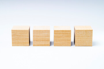four wooden cubes on a white background, copy space and mock up