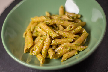 A dish of wholemeal pasta with typical Italian pesto sauce. Pesto alla genovese made with fresh basil