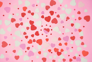 bunch of hearts spread in a pink backround, flat lay