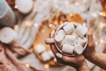 woman's hands holding a marshmallow cup  Christmas card