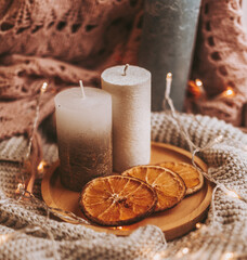 Christmas candle on on a stand with sliced ​​oranges