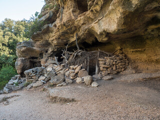 View of old cave shepard shelter on hiking path to Cala Goloritze beach with limestone rocks,...