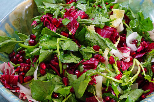 Colorful Winter Salad With Mixed Greens, Belgian Endives And Pomegranate Seeds