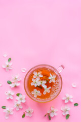 Cup of tea and spring apple blossom on a wooden background