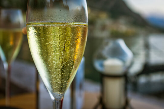 A glass of Italian sparkling wine, known as Prosecco, used as appetizer in a restaurant dehor in the Garda Lake (Lombardy, Northern Italy).