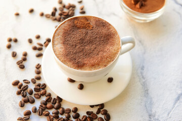 Fototapeta premium Tasty coffee with cinnamon in cup on light background