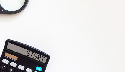 Calculator with text Start on display. Business and financial concept. Place to write