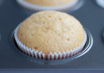  Homemade cupcakes on the oven baking dish in a special form. hot fresh cupcake from the oven