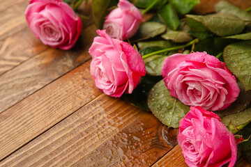 Beautiful pink roses on wooden background