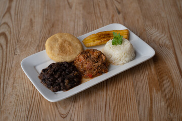 Pabellon Criollo with Arepas, banana, black beans, shredded meat and rice, Venezuelan dish