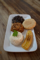Pabellon Criollo with Arepas, banana, black beans, shredded meat and rice, Venezuelan dish